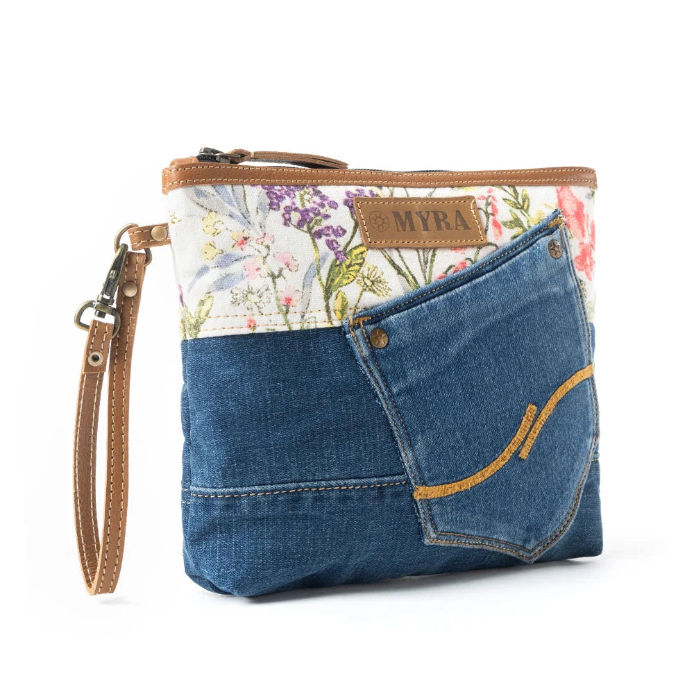 Myra Dahlia Denim Clutch bag with blue denim pocket, floral canvas, leather trim, and wrist strap