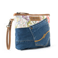 Myra Dahlia Denim Clutch bag with blue denim pocket, floral canvas, leather trim, and wrist strap