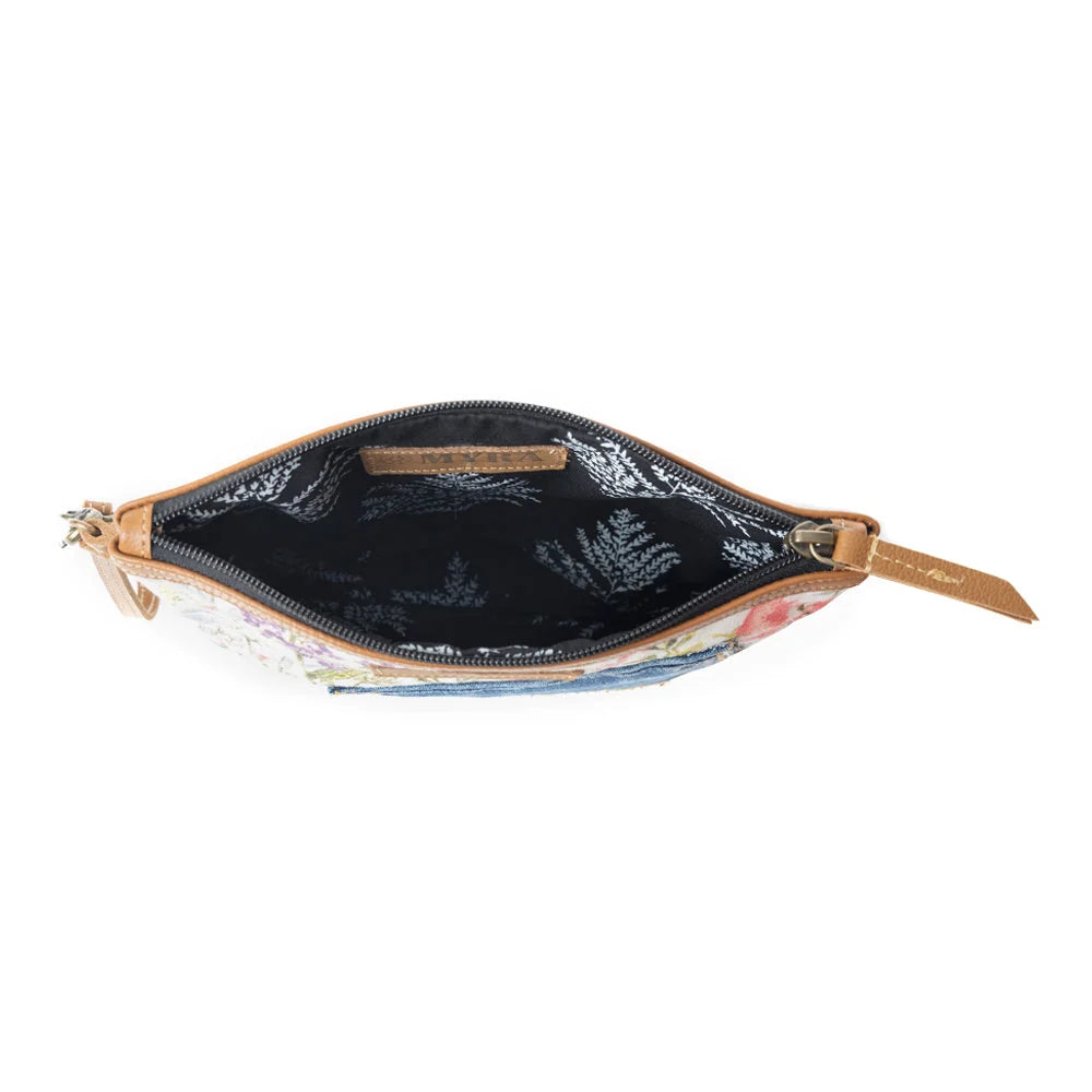 Interior of Myra Dahlia Denim Clutch bag with dark patterned lining and zipper opening