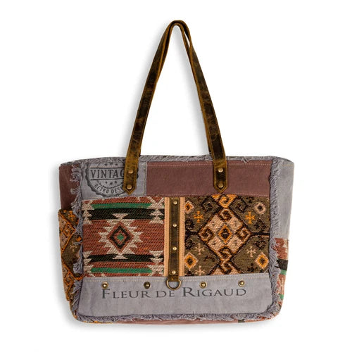 Myra Rigaud Rail Express Western Crossbody Bag with Southwestern rug, upcycled canvas, genuine leather accents, zipper pockets and shoulder strap.