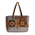 Myra Rigaud Rail Express Western Crossbody Bag with Southwestern rug, upcycled canvas, genuine leather accents, zipper pockets and shoulder strap.