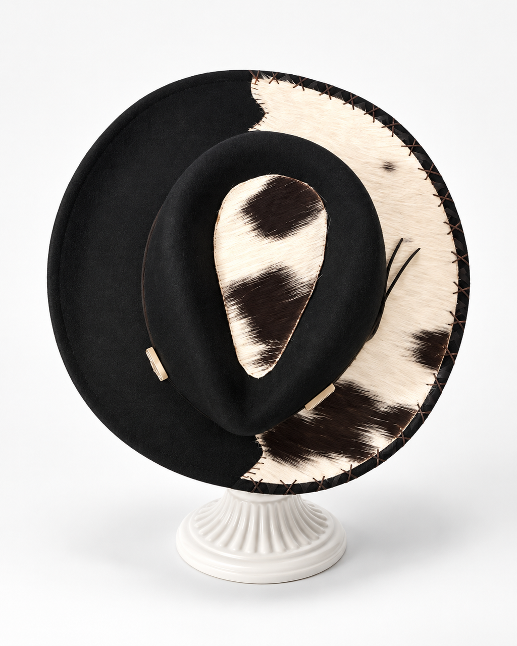 Black 100% wool western cowboy hat with hand-sewn cowhide accents and decorative stitching on a white display stand