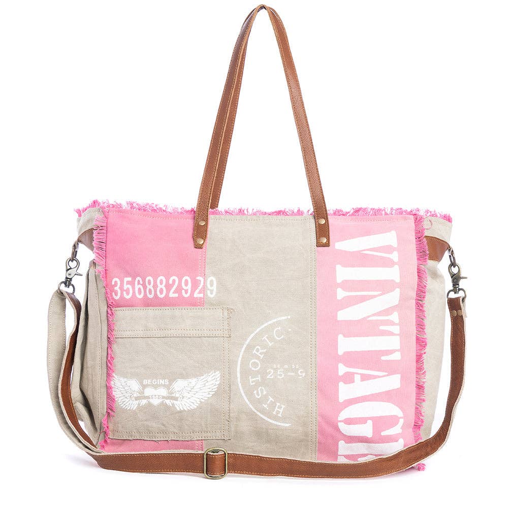 Myra Queen Creek Weekender Bag in Pink with woven canvas, leather handles, frayed edges, and detachable shoulder strap
